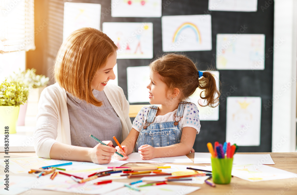 Fototapeta premium mother and child daughter draws in creativity in kindergarten