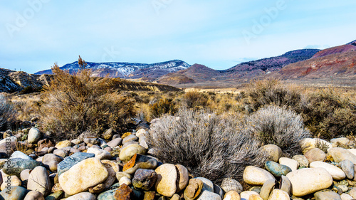 Thompson River flowing through semi desert landscape of the Thompson River Valley viewed from Juniper Beach Provincial Park betweeen Kamloops and Cache Creek, British Columbia, on a cold winter day photo