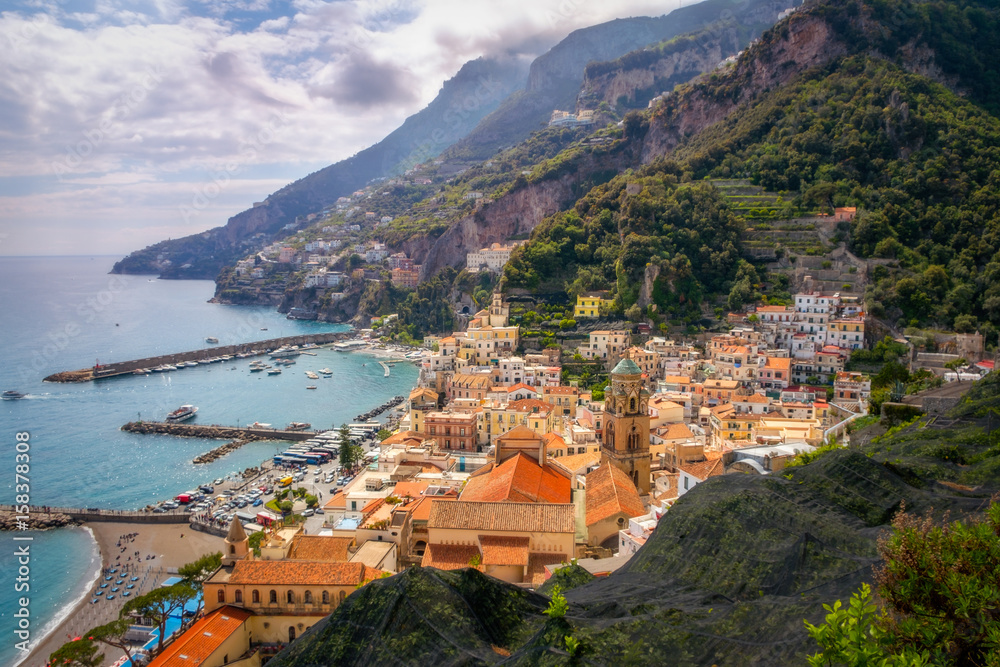 Cityscape view of Amalfi with colorful houses and ocean coastline