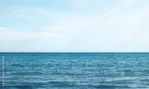 Vacation, travel and background concept - blue sea or ocean with sky