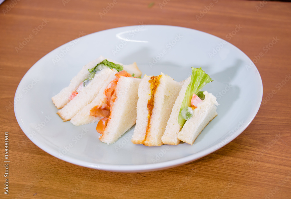 delicious sandwich with ham vegeable bread on white dish , home made sandwich, health food delicious sandwich with ham vegeable bread on white dish , home made sandwich, health food