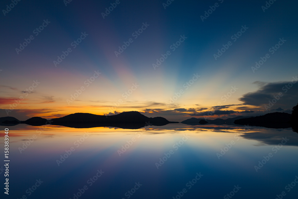 Beautiful colorful color and light sunset over tropical sea with reflection.