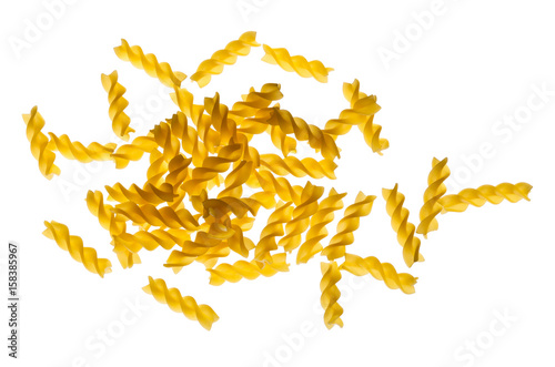Backlit dried raw, uncooked spirelli pasta noodles photo