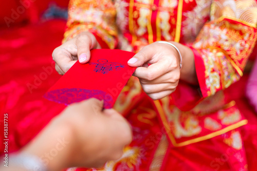 Chinese bride giving red pocket lucky money © creativefamily
