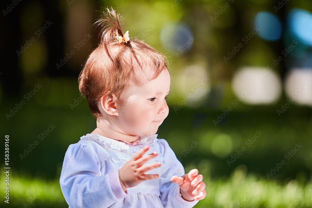 Close-up summer portrait of beautiful baby girl on the lawn in the park. Close-up summer portrait of beautiful baby girl on the lawn in the park.