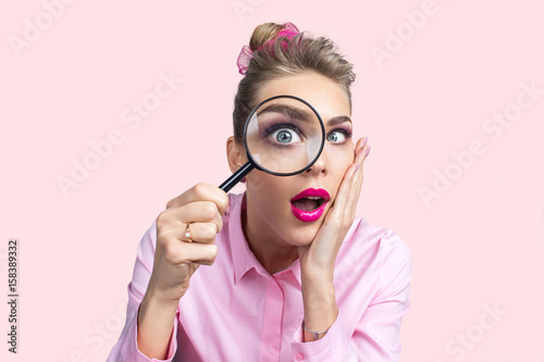 Woman looking through magnifying glass