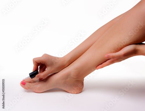 Beautiful feet with perfect spa nail pedicure on white background