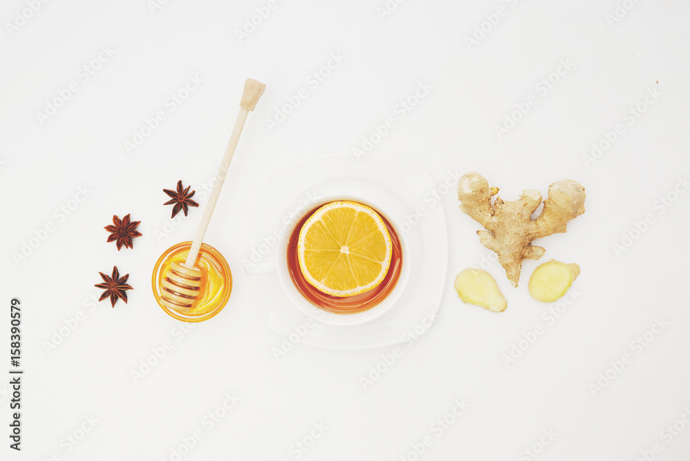 Herbal tea with lemon and ginger over white background. Flat lay, top view, copy space Herbal tea with lemon and ginger over white background. Flat lay, top view, copy space