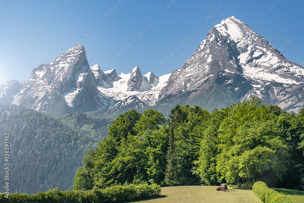 Tractor in front of the imposing Watzmann, Bavaria, Germany