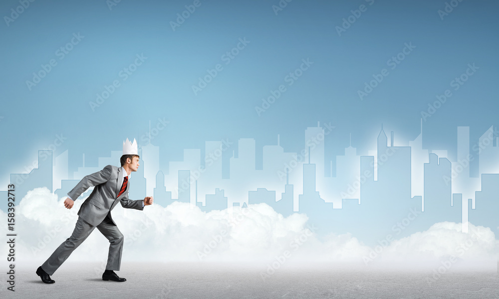 King businessman in elegant suit running and blue cityscape silhouette at background King businessman in elegant suit running and blue cityscape silhouette at background