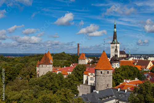 Aerial view of Tallinn old town in a beautiful summer day, Estonia. Deep green mood with red towers.