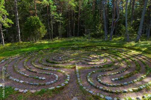 Mystic oriental stone labyrinth in green forest, aestetic symbol