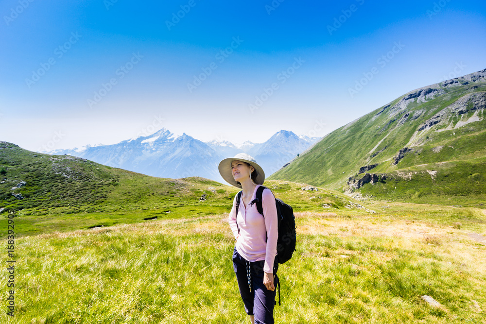 Woman hiking in mountains at summer