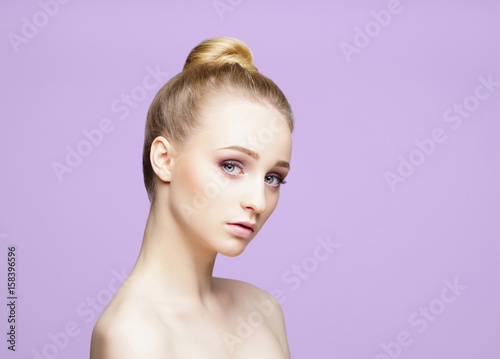Beauty close-up portrait of beautiful, fresh and healthy girl over magenta background.