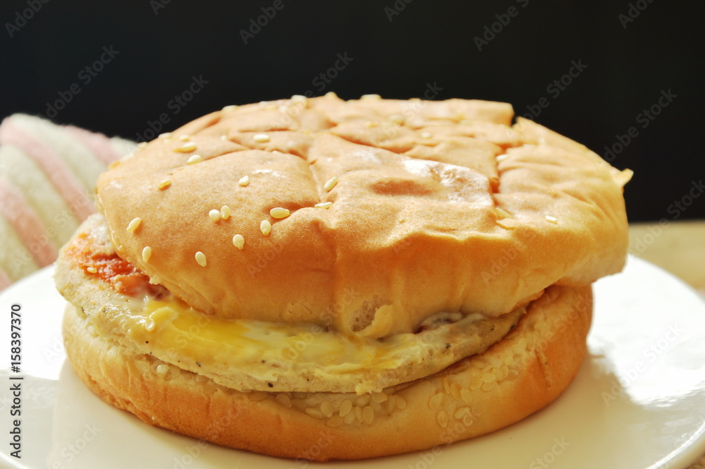 chicken hamburger on dish in black background chicken hamburger on dish in black background