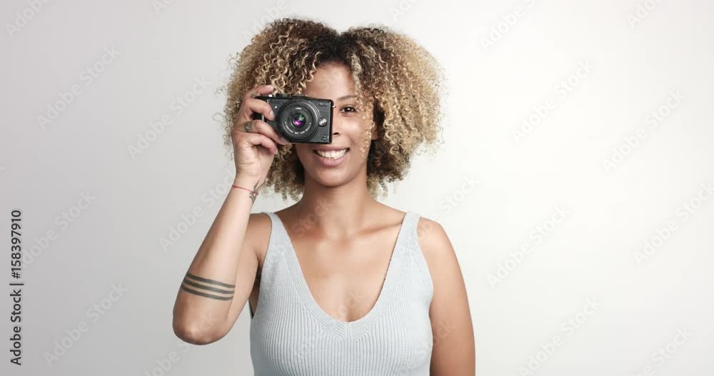 happy smiling black woman with afra makes shoots with photocamera happy smiling black woman with afra makes shoots with photocamera