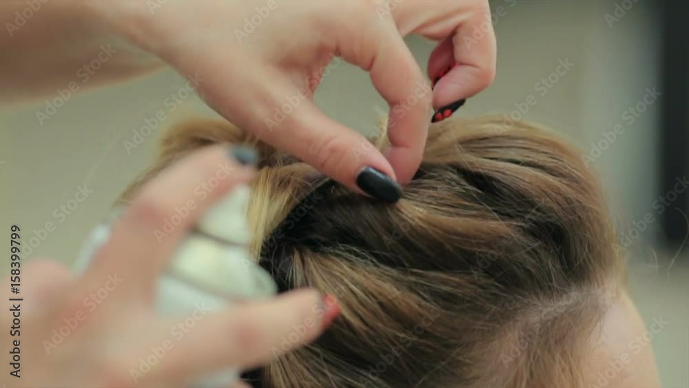 the hairdresser doing hairstyle in beauty salon. Young woman in a beauty salon, beauty the hairdresser doing hairstyle in beauty salon. Young woman in a beauty salon, beauty