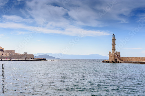 Beautiful view from shore to white lighthouse in port