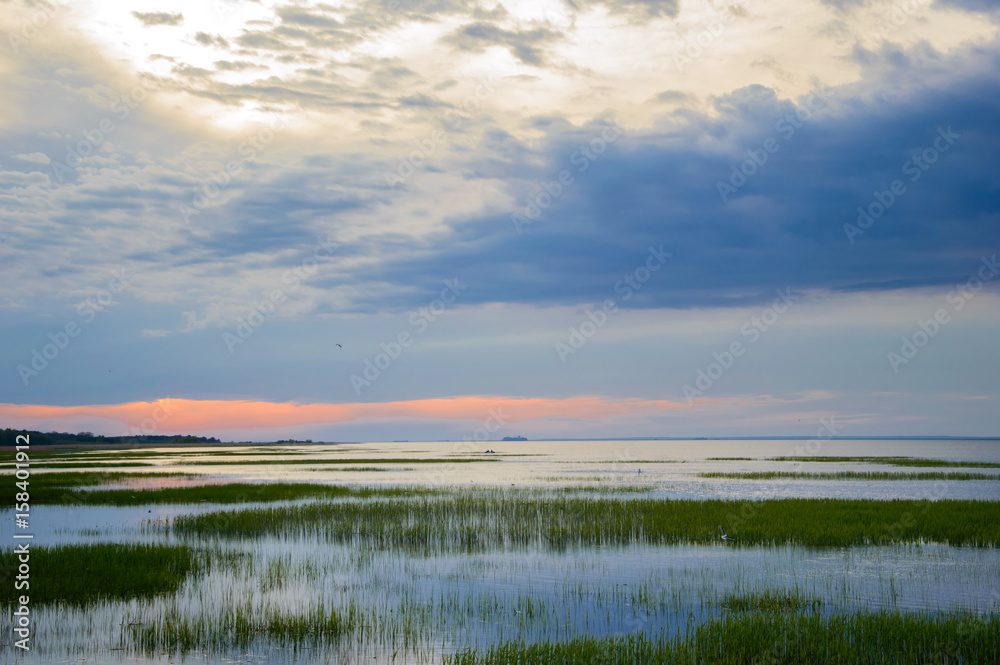 Sunset idyllic over the Bay. Landscape of the marine in the evening. The nature of the sea in calm.