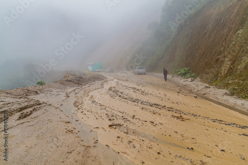VILCABAMBA, ECUADOR - JUNE 15, 2015: Mud is flowing on the road as a result of landslide. Road Zumba - Vilcabamba.