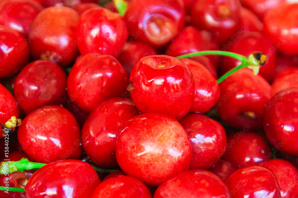 Red cherries, with water droplets.Close-up of red cherries. Background of red berries or fruits Red cherries, with water droplets.Close-up of red cherries. Background of red berries or fruits