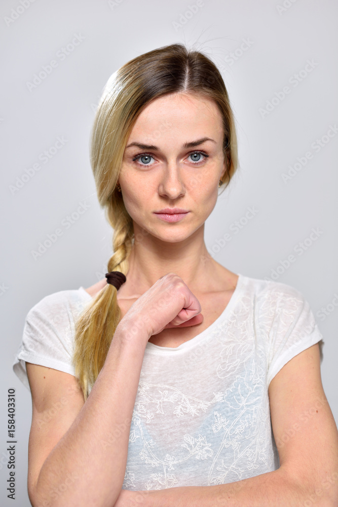 Portrait serious girl on a white background Portrait serious girl on a white background