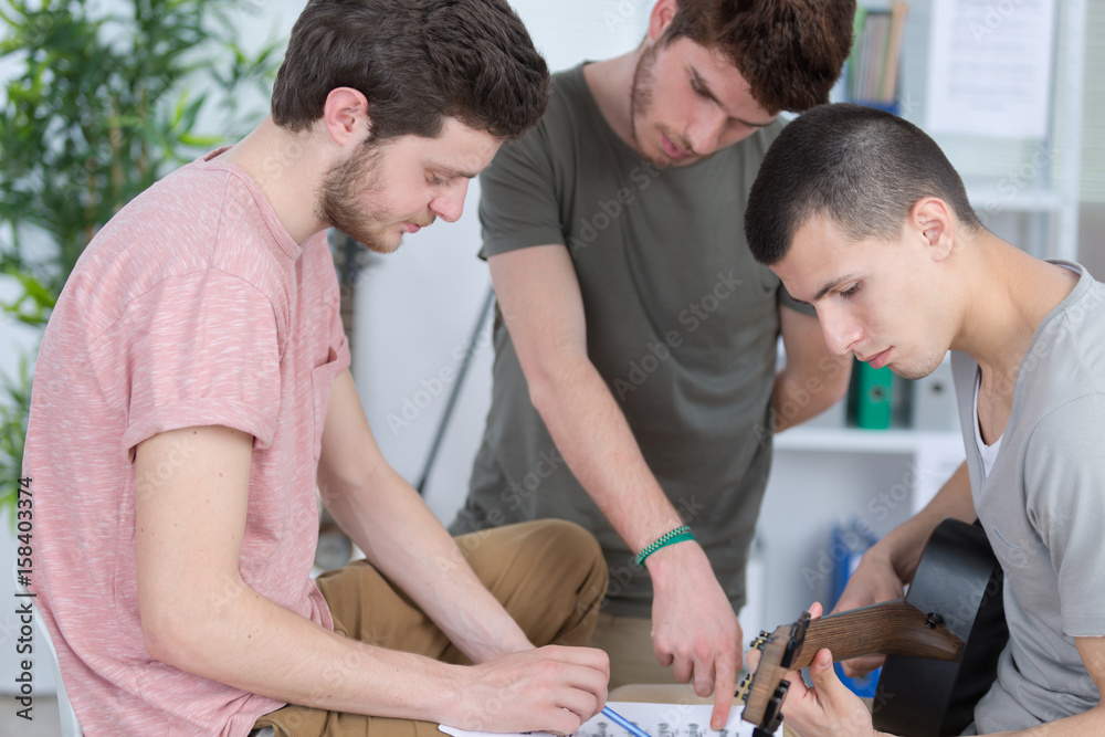 Fototapeta premium Young men composing music for guitarist