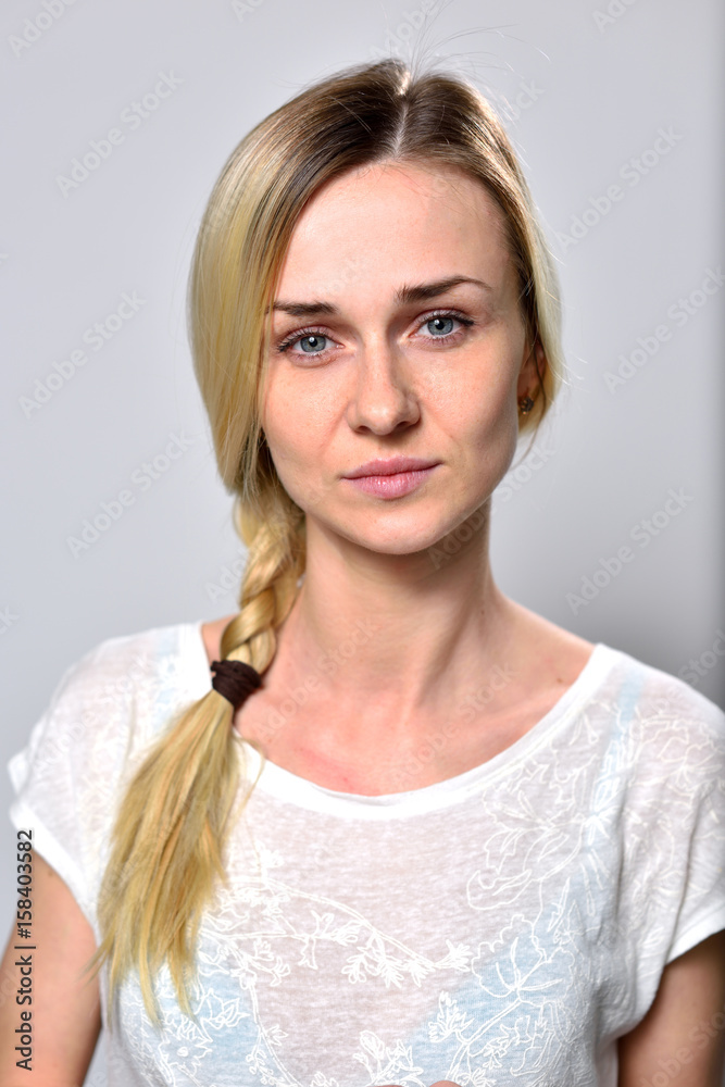 Beautiful blonde girl portrait close-up look at the camera Beautiful blonde girl portrait close-up look at the camera