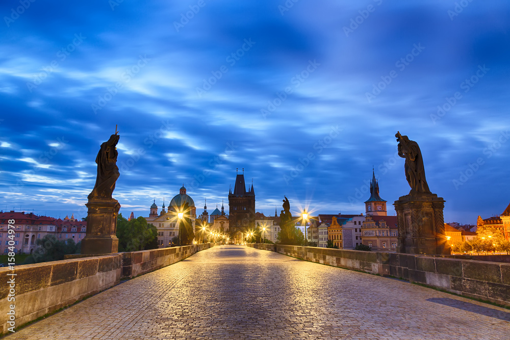View of Charles Bridge in Prague with blue sky and clouds, Czech Republic during blue hour sunrise