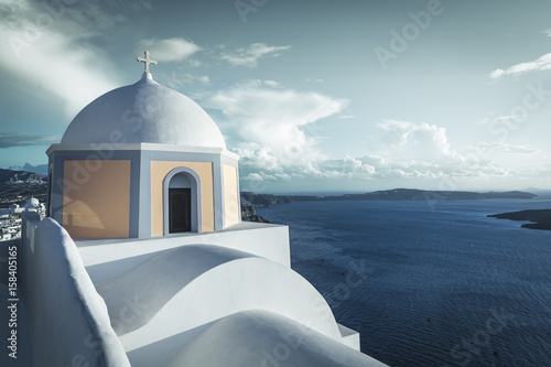 Traditional greek church on the cliff, Santorini Island, Greece. Desaturated colors