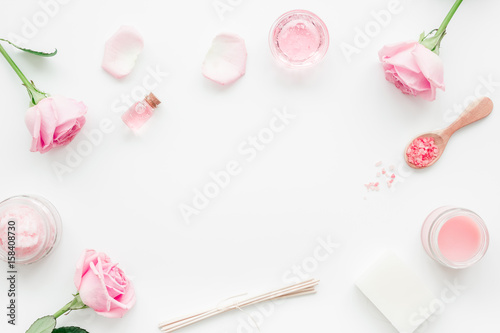 spa set with rose flowers and cosmetic for body on white desk background top view mockup