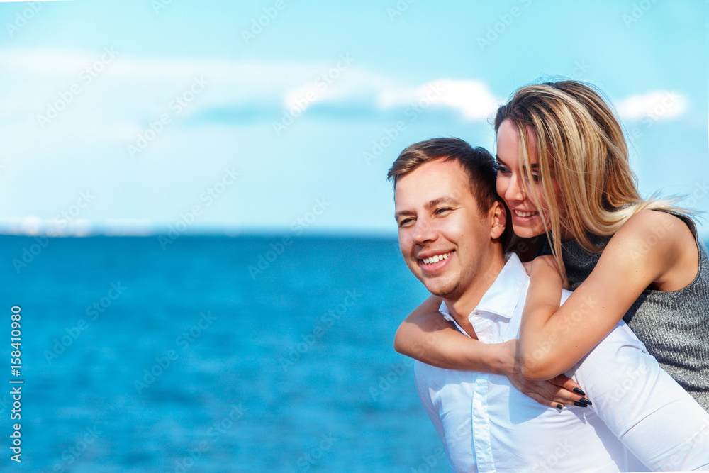 Happy couple on sea background. happy young romantic couple in love have fun on l beach at beautiful summer day