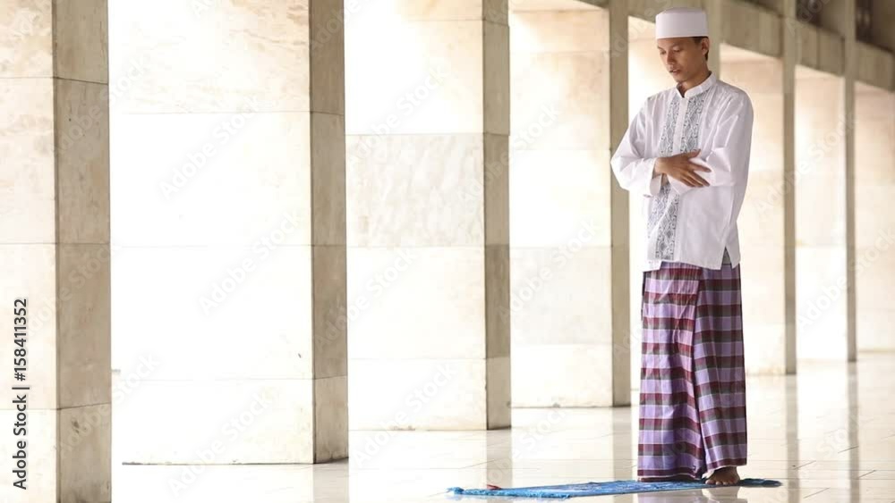  
Young religious person praying alone in the mosque with poses of standing, bowing, prostration, sitting, second prostration, second sitting, and greetings or taslim
