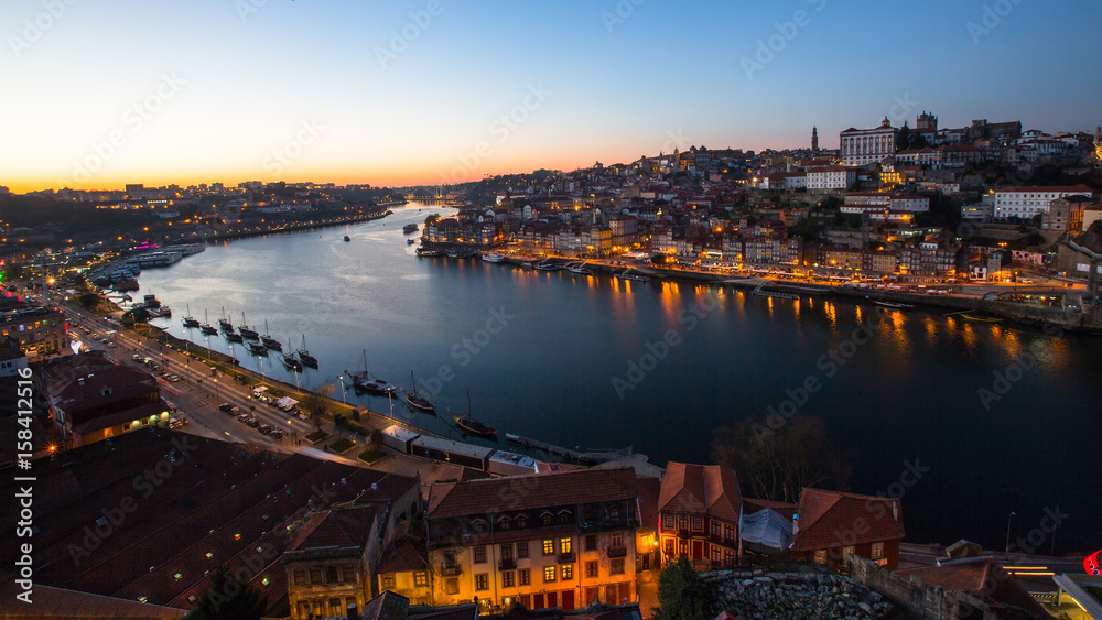 View of Douro river and Ribeira at night time, Porto, Portugal..