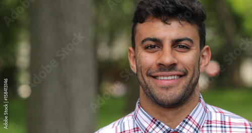 Young man in city park face portrait