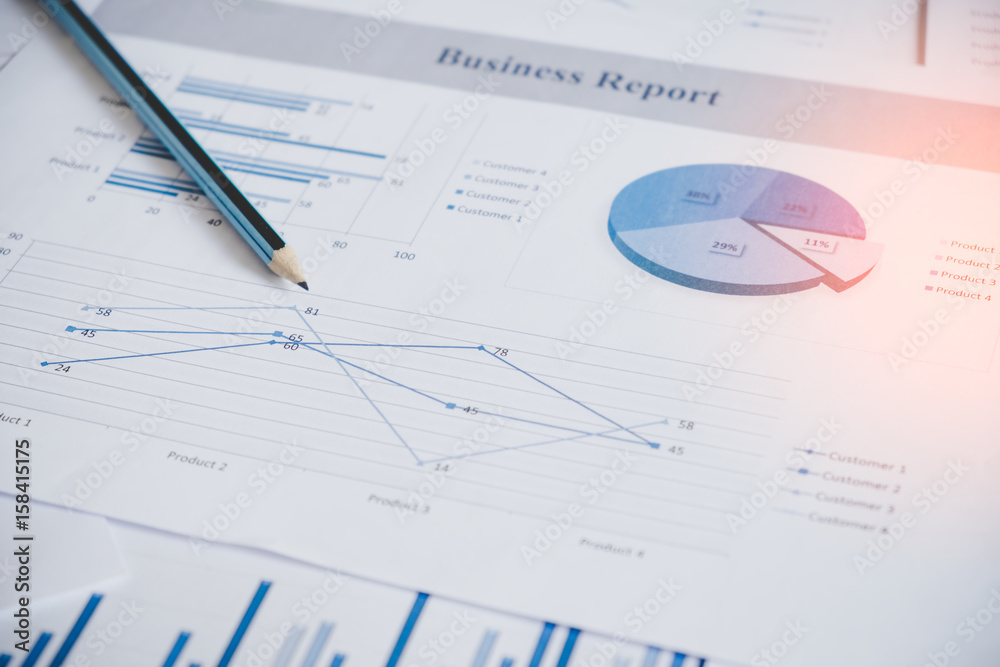 Many charts and graphs with pen-pencil. Reflection light and flare. Concept image of data gathering and statistical working. Many charts and graphs with pen-pencil. Reflection light and flare. Concept image of data gathering and statistical working.