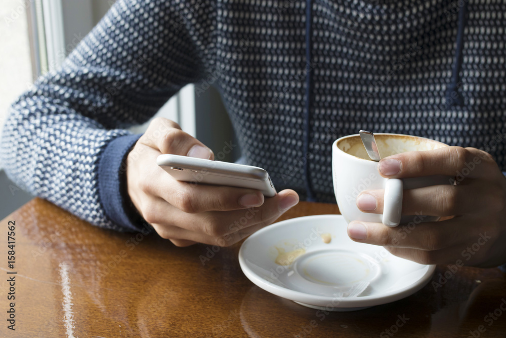 hands with mobile phone taking coffee in the cafeteria hands with mobile phone taking coffee in the cafeteria