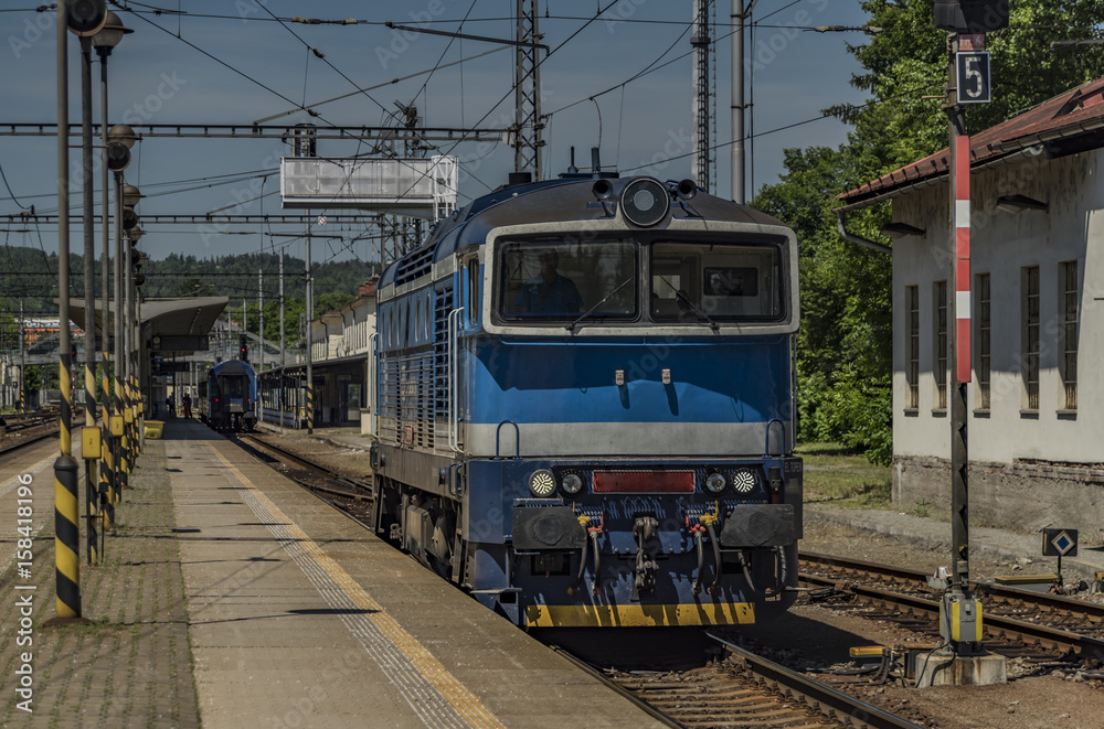 Blue motor engine near fast train Blue motor engine near fast train