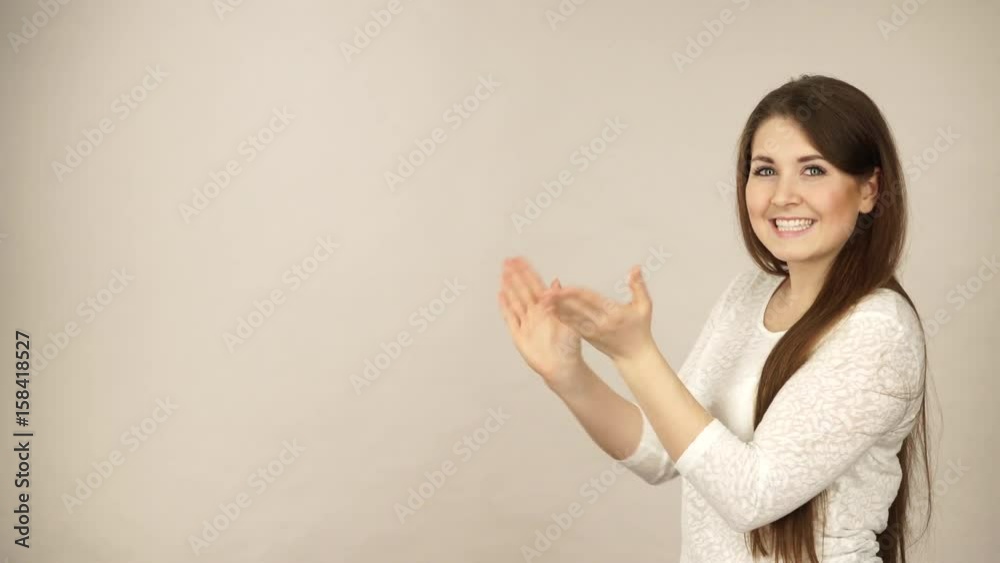 Woman showing presenting, long haired fashionable girl holding empty hand palm copy space for product, making thumb up gesture sign. Advertisement concept. Studio shot on grey background 4K ProRes HQ Woman showing presenting, long haired fashionable girl holding empty hand palm copy space for product, making thumb up gesture sign. Advertisement concept. Studio shot on grey background 4K ProRes HQ