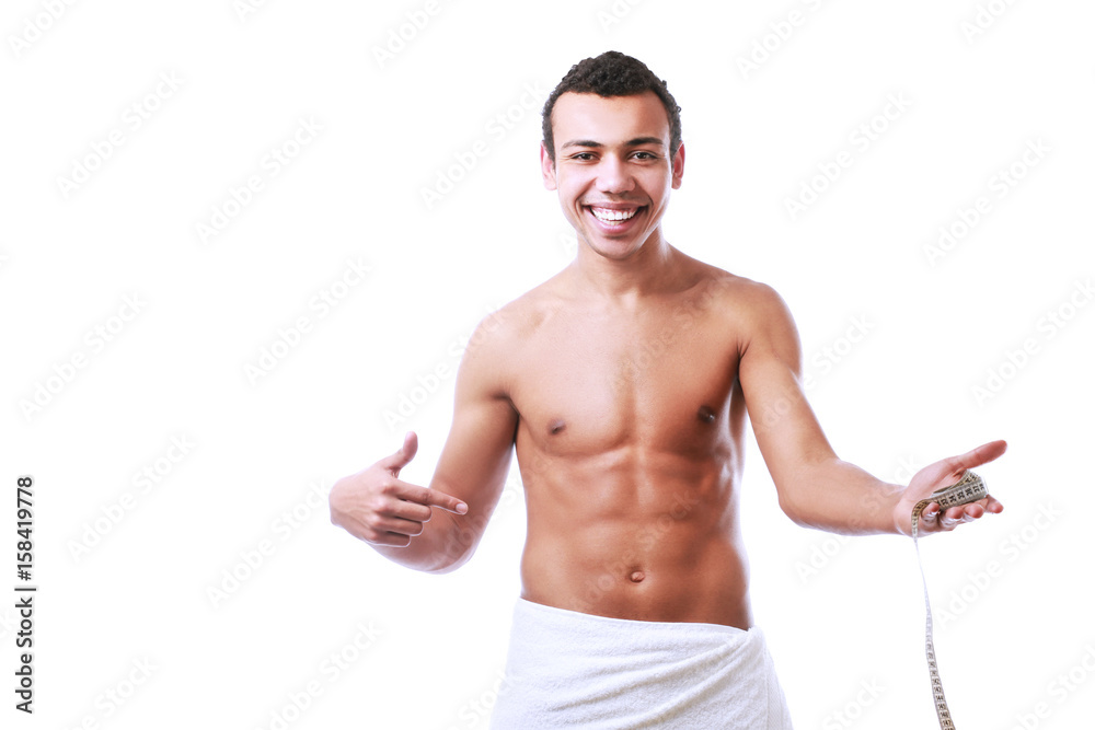Young muscular man wrapped in a white towel isolated on white background Young muscular man wrapped in a white towel isolated on white background