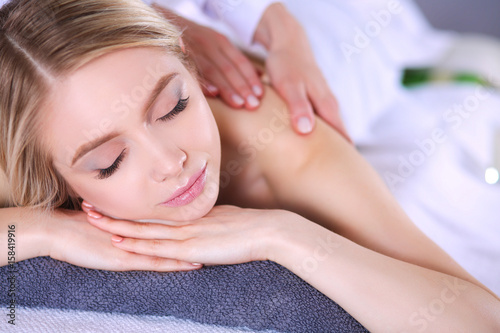 Young woman lying on a massage table,relaxing with eyes closed