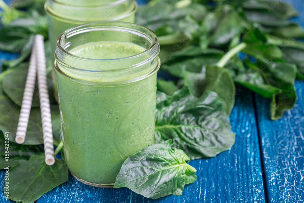 Detox green smoothie with spinach, pineapple, banana and yogurt, horizontal, copy space
