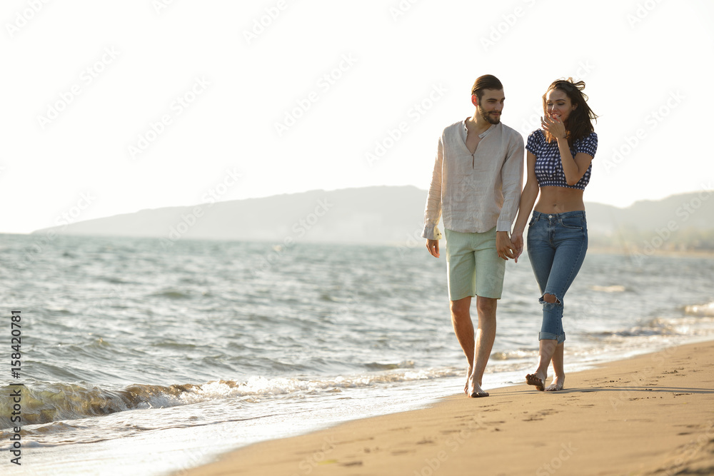 happy couple waling on the beach and having fun happy couple waling on the beach and having fun