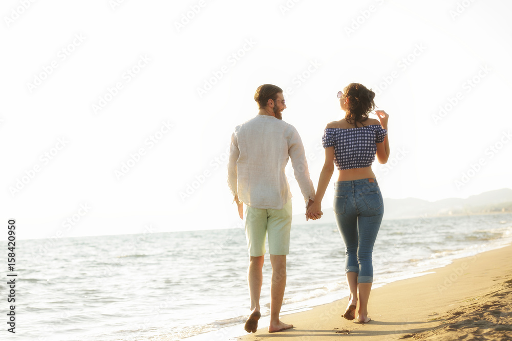 happy couple waling on the beach and having fun happy couple waling on the beach and having fun