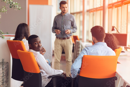 business, startup, presentation, strategy and people concept - man making presentation to creative team at office