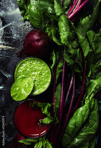 Detox smoothies from raw beets and spinach, dark food background, top view