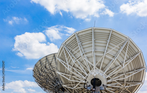 picture of parabolic satellite dish space technology receivers under blue sky