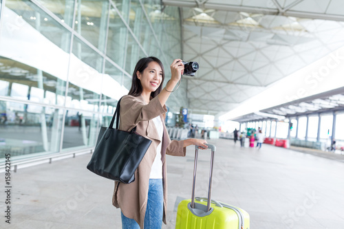 Woman taking photo with digital camera