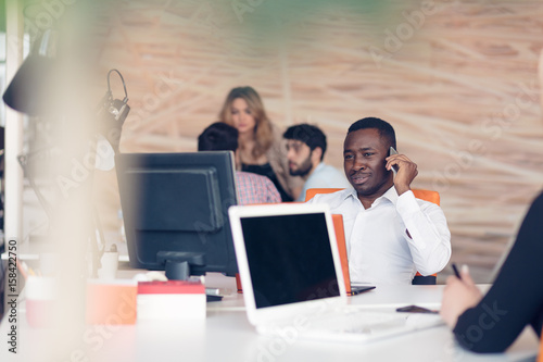 African American businessman sitting at the computer in startup office