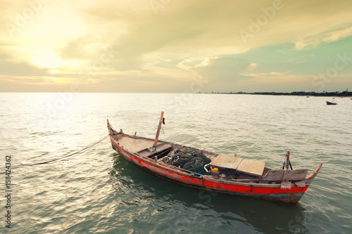 Old fishing boat on the sea coast of Thailand.